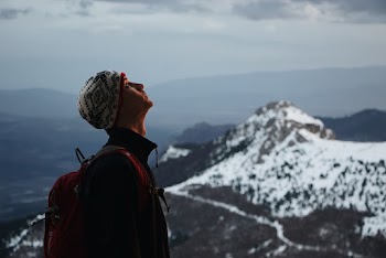 Man Standing on Snow-capped Mountain