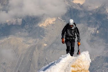 man standing on snow during daytime