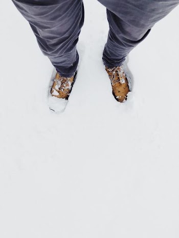 man standing on snow field