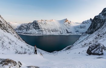 man standing on snow path