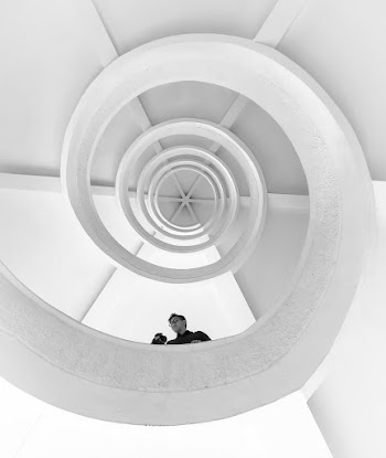 Man Standing On Spiral Stairs