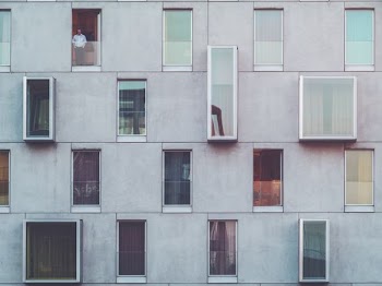 man standing on tenement door