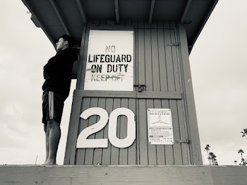 Man Standing on the Life Guard House