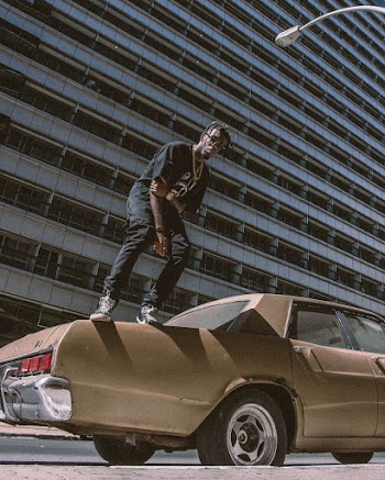 Man Standing On Top Of Beige Car