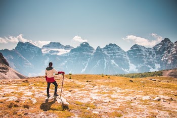 Man Standing on Top of Mountain