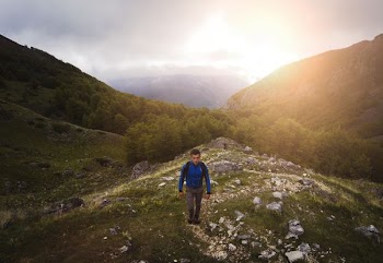man standing on top of mountain