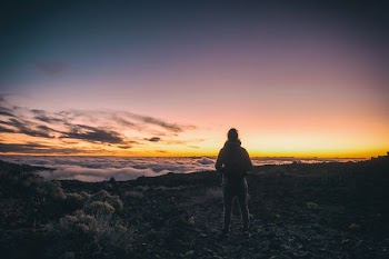 man standing on top of mountain