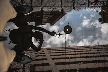 Man Standing on Water Capturing Airplane Reflection