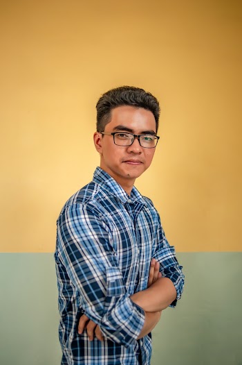 Man Standing on Yellow and Green Wall