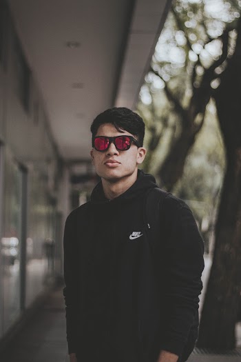 Man Standing Outdoor While Wearing Sunglasses