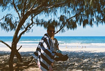 Man Standing Under A Tree