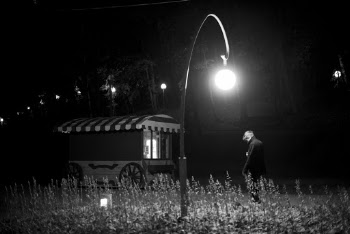 Man Standing Under Lamppost