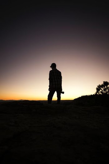 man standing under white and black sky