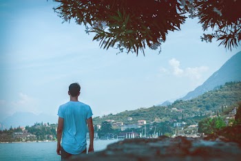 Man Standing While Facing Body of Water