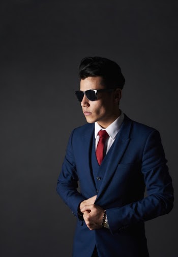 Man Standing While Holding His Blue Blazer