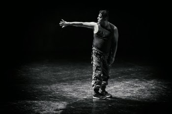Man Standing While Raising His Hand