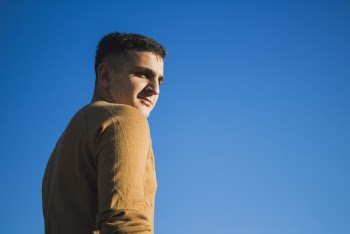 Man Standing While Wearing Brown Sweater