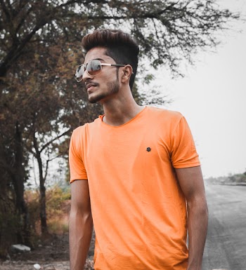 Man Standing While Wearing Orange Crew-neck Shirt Near Tree