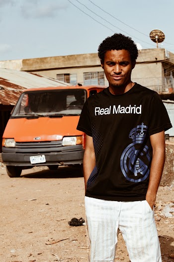 Man Standing With Both Hands in His Pockets in Front of Vehicle