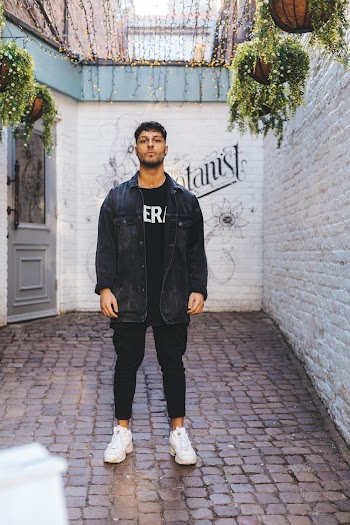 Man Stands in Middle of Courtyard