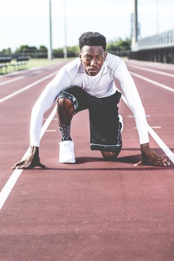 man starting to run in field