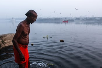 Man Stepping in the Body of Water