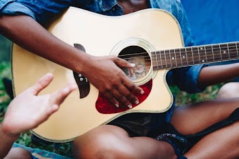 man strumming guitar