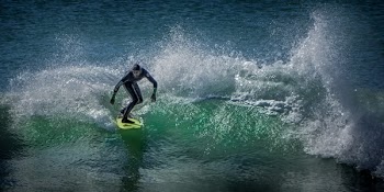 Man Surfing on Body of Water