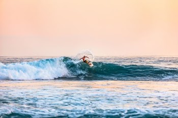 man surfing on sea during daytime