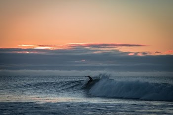 man surfing with giant waves