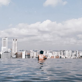 Man Swimming in Infinity Pool