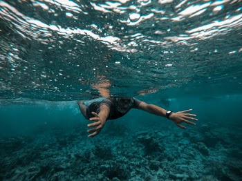 Man Swimming on Body of Water