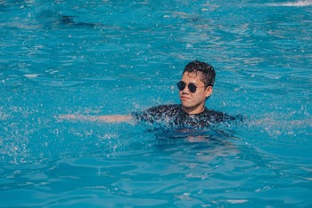 Man Swimming on Pool