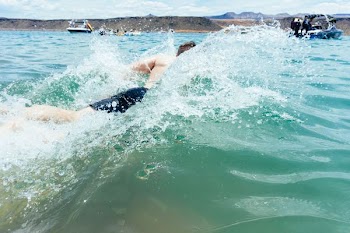 man swimming on sea
