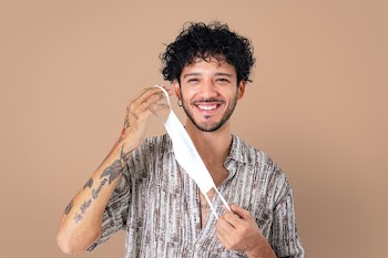 Man taking mask off during the new normal | Free stock photo | High Resolution image