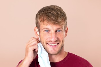 Man taking mask off during the new normal | Free stock photo | High Resolution image