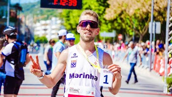 Man Taking Photo and Holding 1 Number Tag