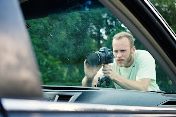Man Taking Photo Near Vehicle