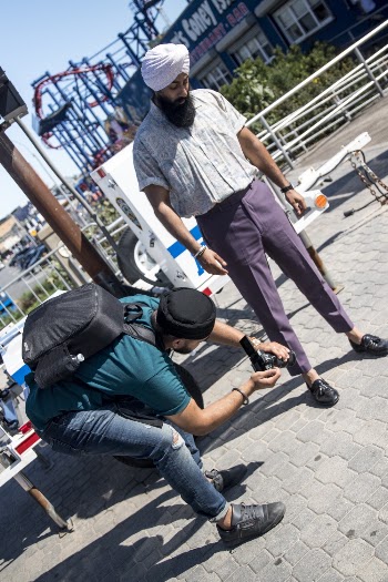 Man Taking Photo of a Man Wearing Purple Pants