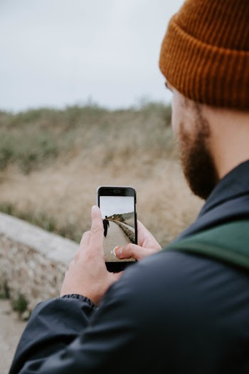 Man Taking Photo of Person Walking
