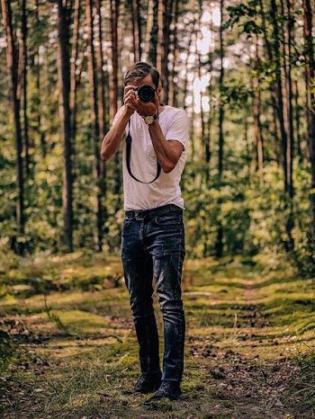 Man Taking Photo Using Camera