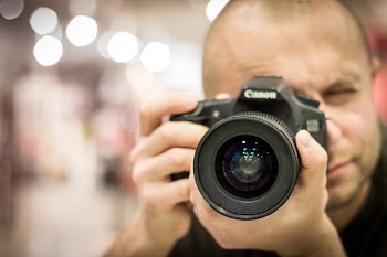 Man Taking Photo With Canon Black Camera