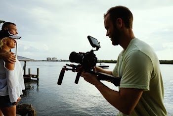 Man Taking Picture of Couple on Dock