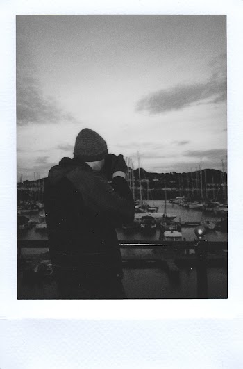 Man Taking Pihoto of Boats