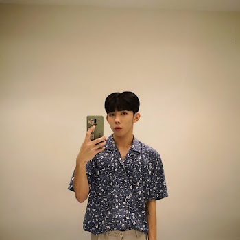 Man Taking Selfie In Front Of Mirror