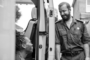 Man Talking with Woman Beside Vehicle