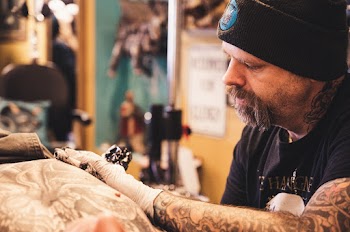 Man Tattooing Person