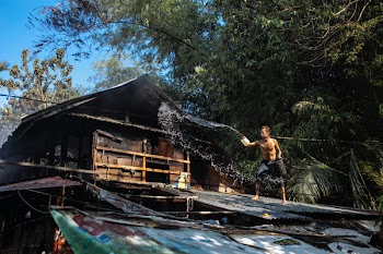 Man Throwing Water on Roof