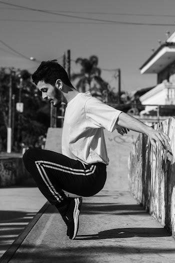 Man Tiptoeing While Sitting on Concrete