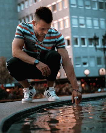 Man Touching Body of Water